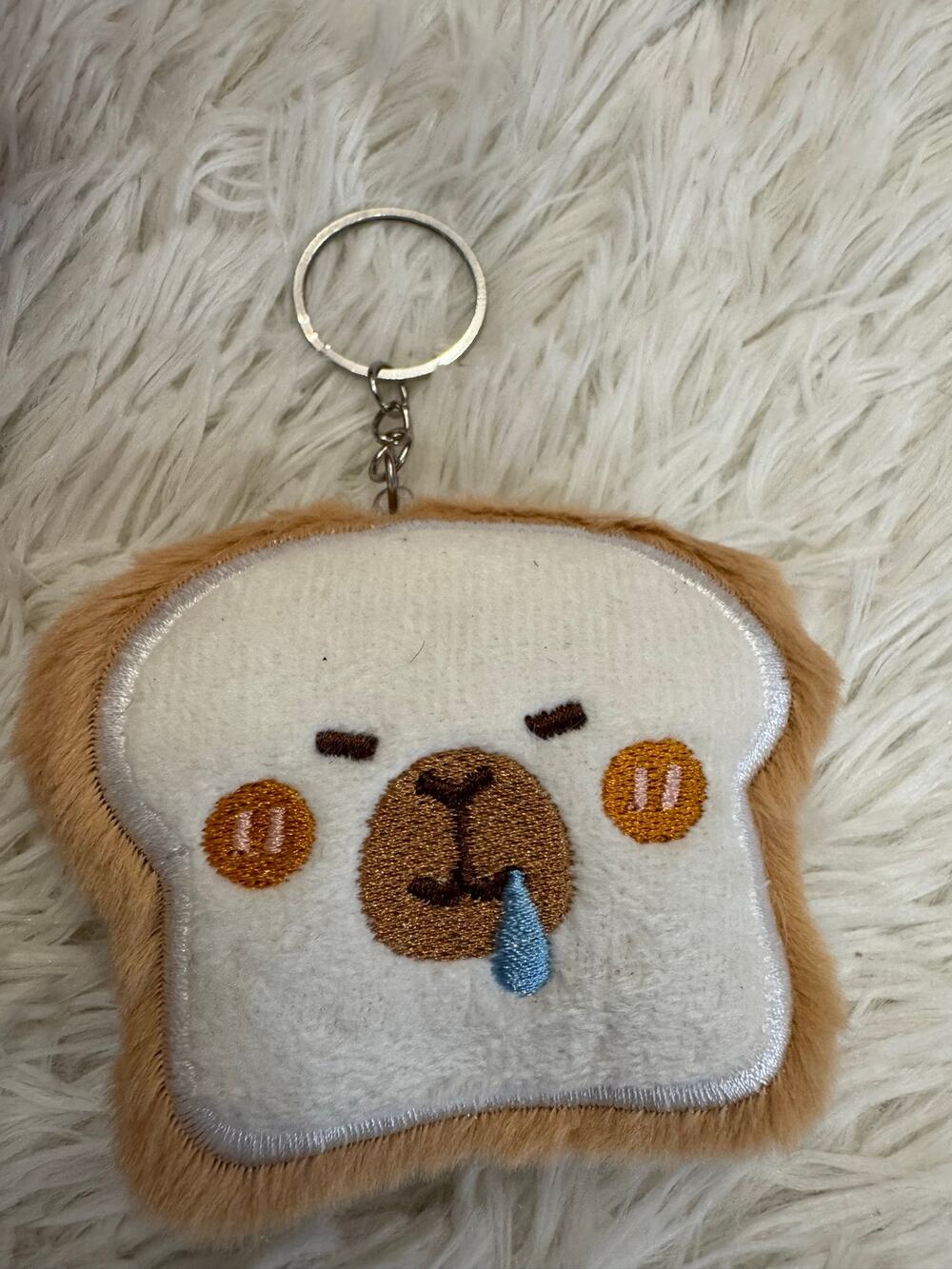 Capybara  bread  toast keychain with embroidered face on a slice of bread